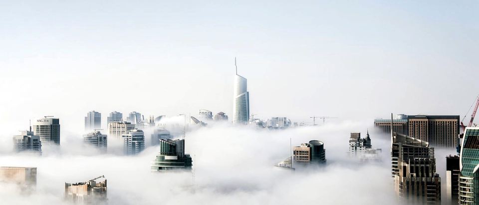 A skyline rising above the clouds