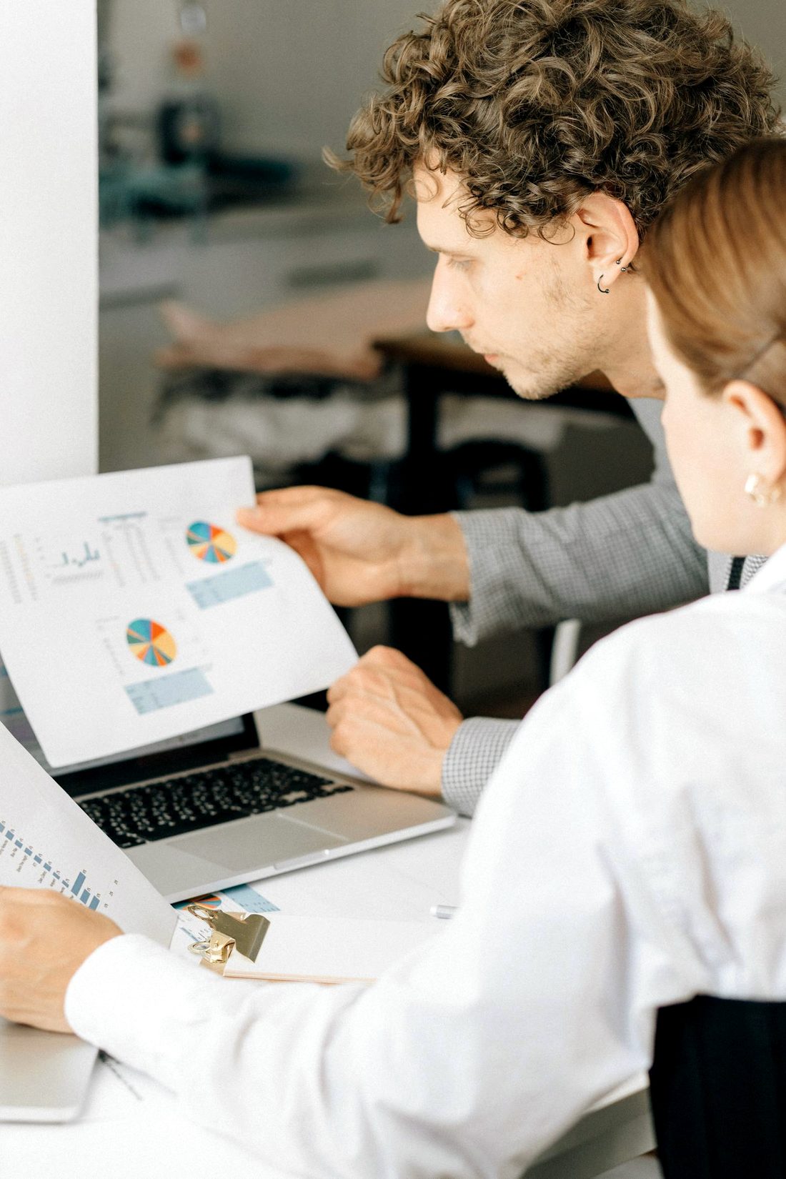 A senior financial advisor reviewing management accounts and forecasts with a business owner